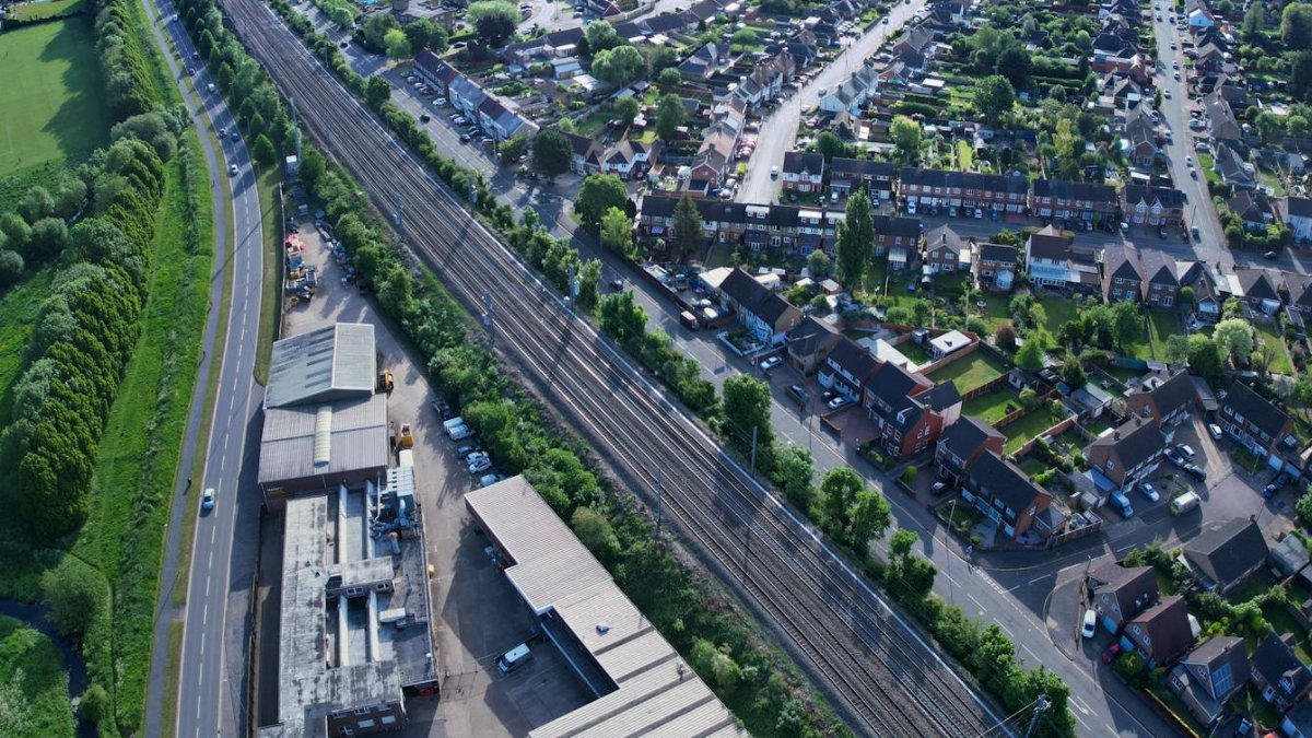 Aerial view of Luton, UK, showcasing urban architecture, roads, and greenery.