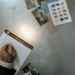 Officers at work reviewing evidence and taking notes in an investigation setting.