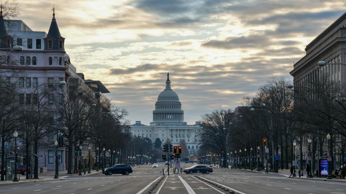 The US Capitol Building captured from a street view in Washington D.C. at sunrise.