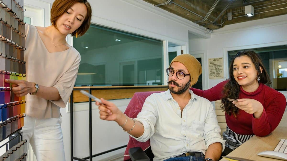 A diverse team discusses design choices in a modern office environment.