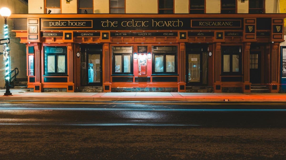 Exterior of aged historical building of famous restaurant located on street of St John s city at night
