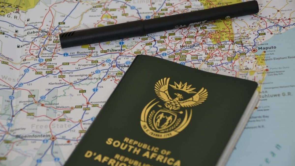 A South African passport rests on a detailed map, symbolizing travel and exploration.
