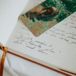A close-up of an open journal with handwritten text and a colorful bookmark, evoking creativity.