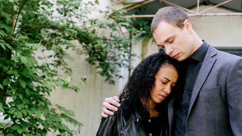 A couple embraces outdoors, conveying an emotional connection. Perfect for themes of love and empathy.