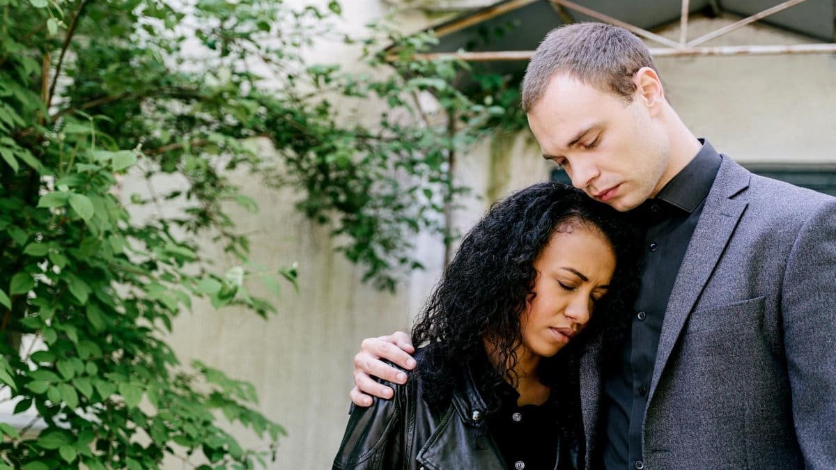 A couple embraces outdoors, conveying an emotional connection. Perfect for themes of love and empathy.