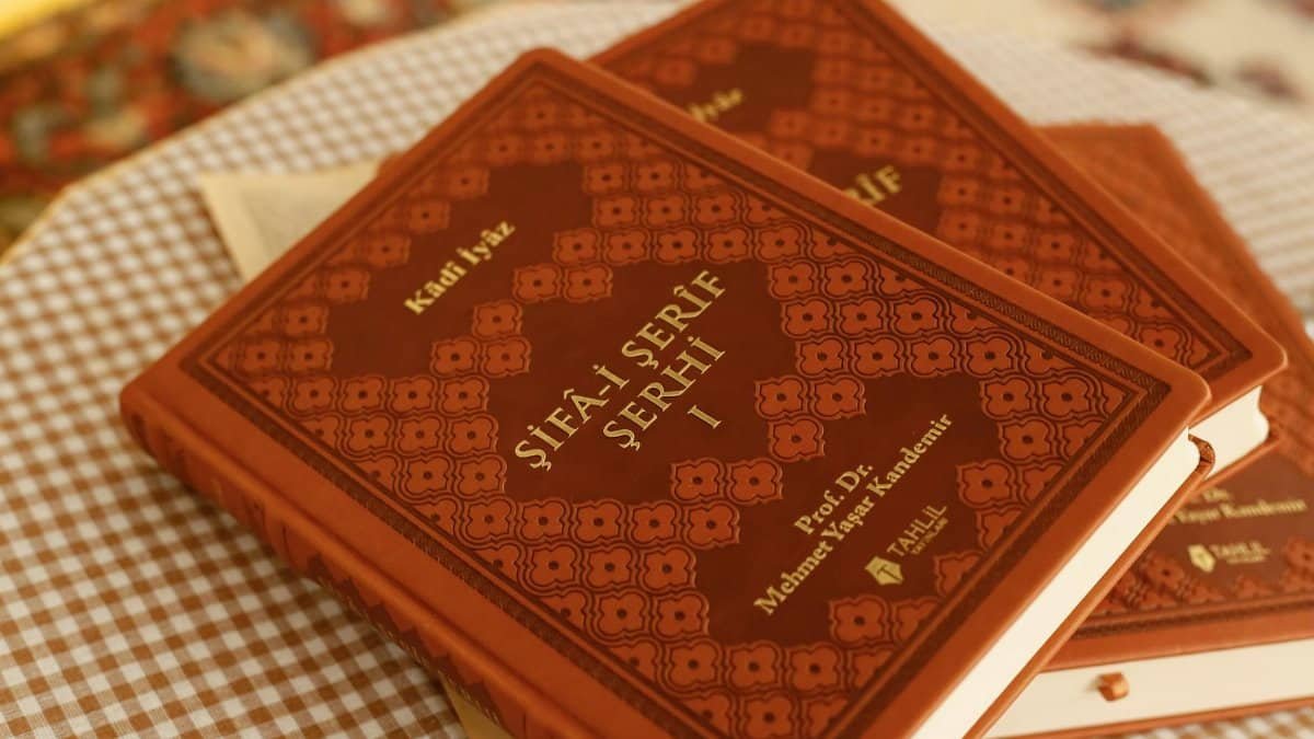 Close-up of traditional books with ornate covers on a checkered tablecloth, creating a vintage ambiance.