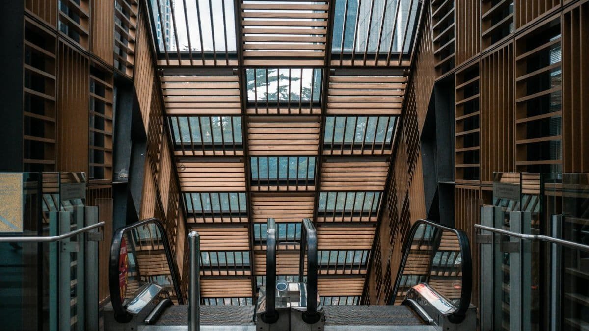 A symmetrical view of a modern escalator inside a building with unique architectural design.