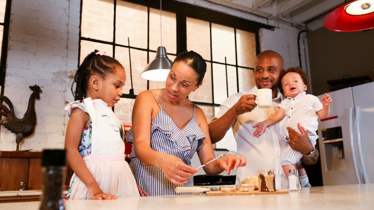 A family spending quality time preparing food in the kitchen, enjoying morning activities.