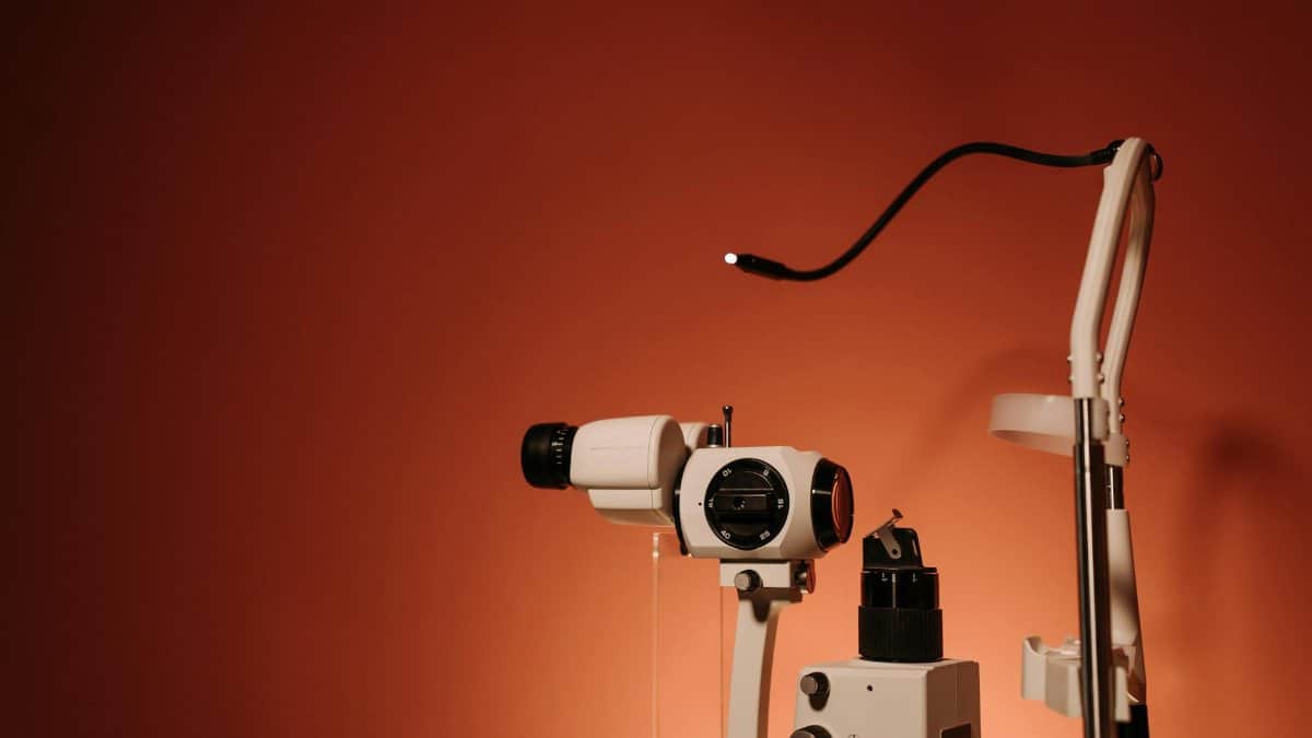 A slit lamp with fine optics on a brown background, ideal for healthcare promotions.