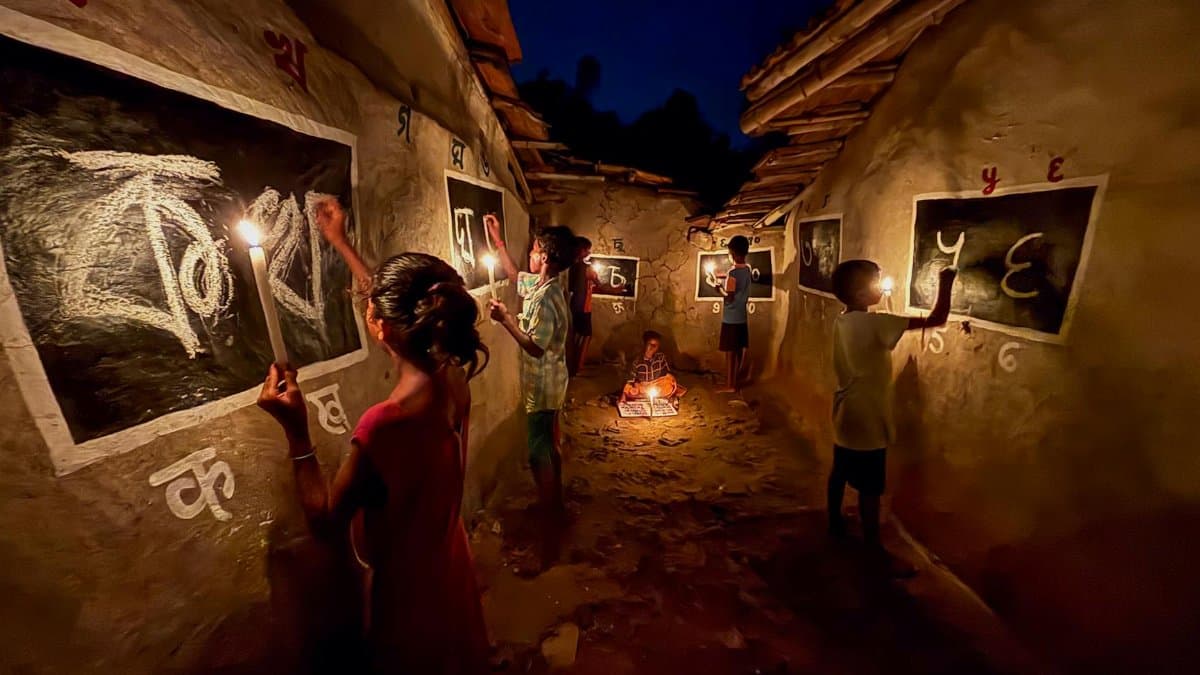 Children learning by candlelight in a rural Indian village at night, embracing education.