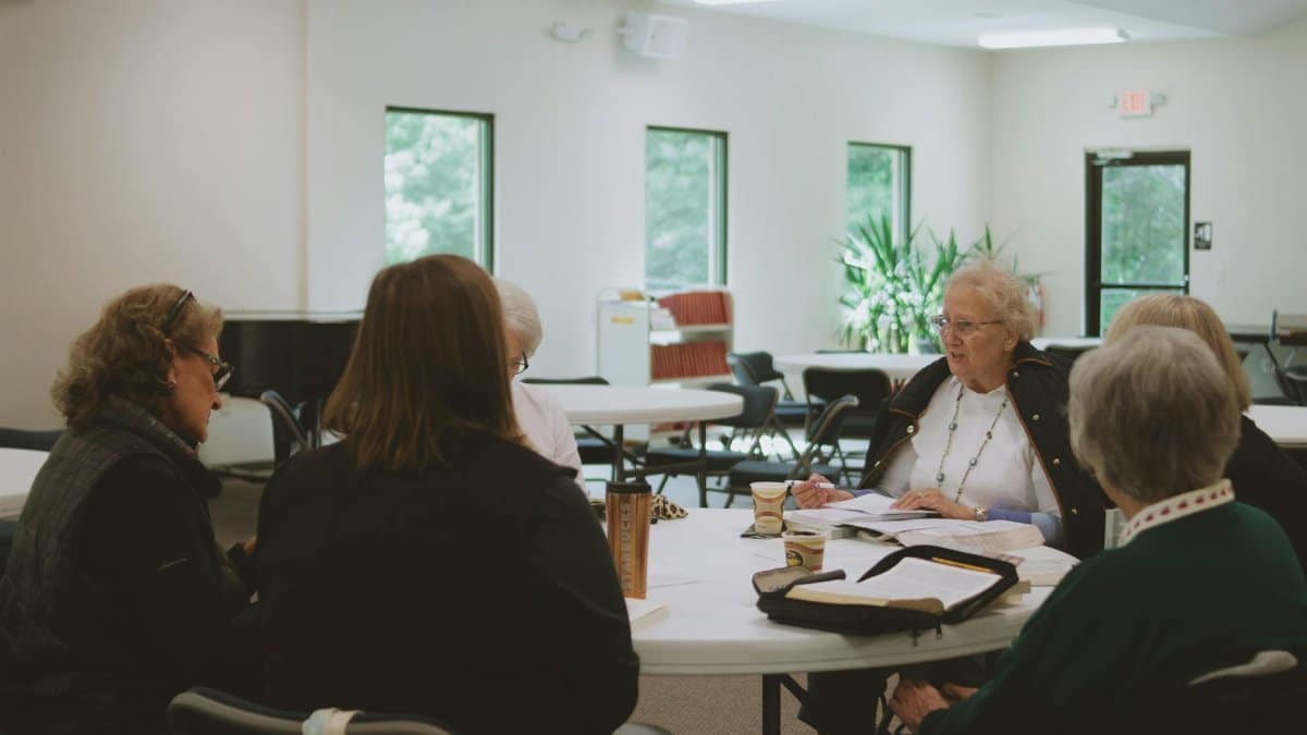 Older women engage in a thoughtful Bible study session at a local church in Brevard, NC.