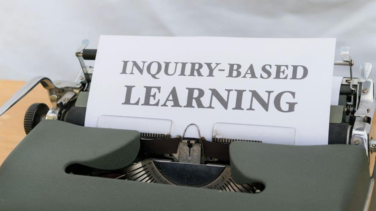 Vintage typewriter displaying 'Inquiry-Based Learning.'