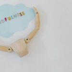 Wooden mannequin holding a mindfulness speech bubble for relaxation and mental health concepts.