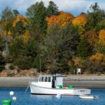 Tranquil autumn scene with a moored fishing boat in Marblehead Harbor, Massachusetts.