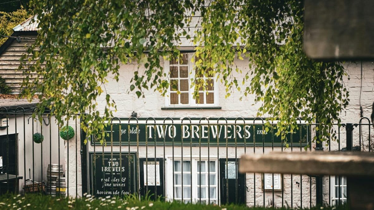 Charming view of Two Brewers pub in rural Shaftesbury, England, showcasing its traditional exterior.