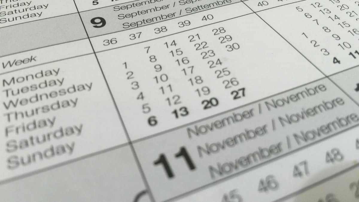 Detailed close-up of a calendar displaying months in several languages.