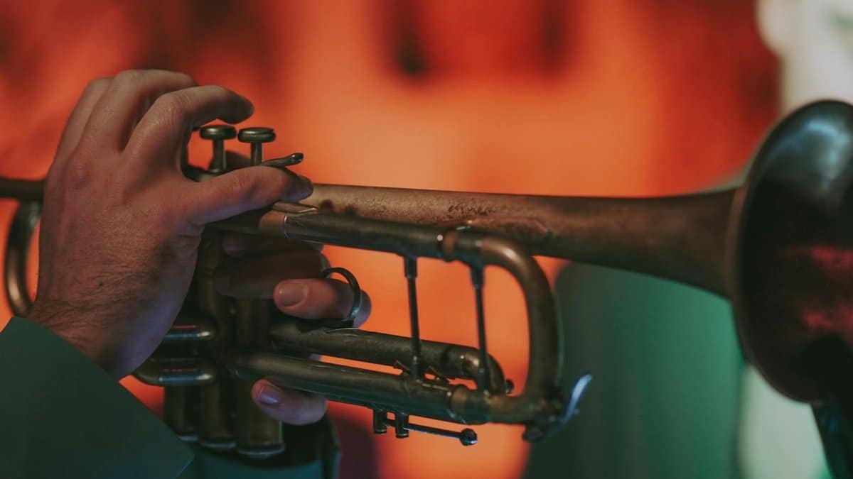 A musician skillfully playing a trumpet in an atmospheric setting, capturing the essence of live music.