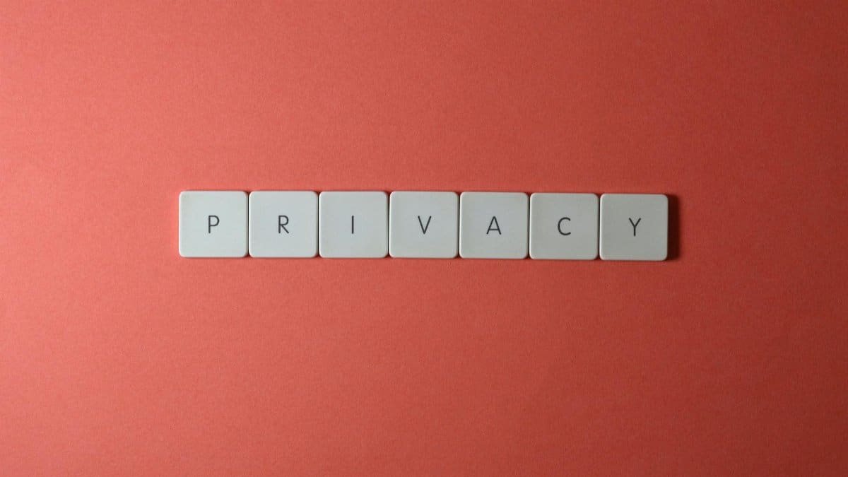 Close-up of letter tiles spelling PRIVACY on a red background, symbolizing data protection.