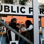 People socializing in a modern New York cafe with a trendy interior design.
