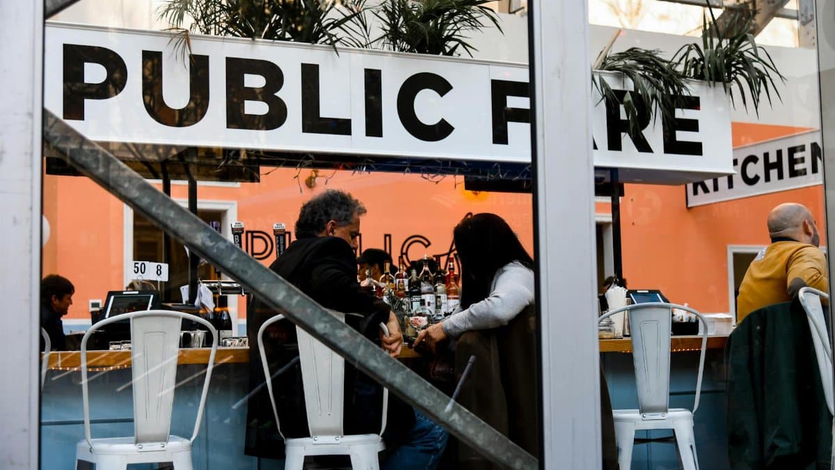 People socializing in a modern New York cafe with a trendy interior design.