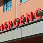 Close-up of a modern hospital emergency room entrance with prominent red letters.