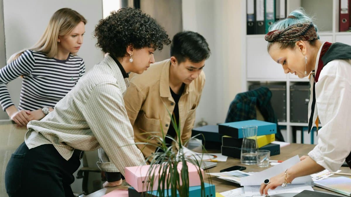 A diverse team of colleagues collaborating on a business project in a modern office setting.