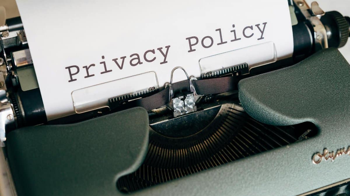 Close-up of a vintage typewriter featuring a privacy policy document in focus, highlighting classic technology.
