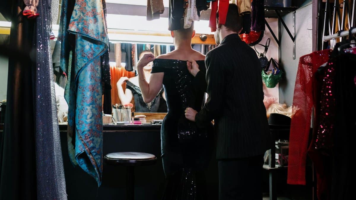 A captivating backstage moment showing the transformation process with dresses and makeup.