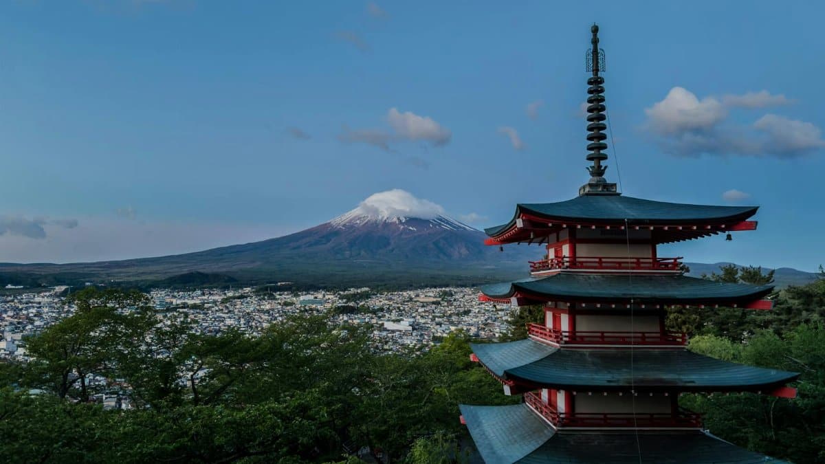 Beautiful landscape of Chureito Pagoda with Mount Fuji in the background, under a clear blue sky.