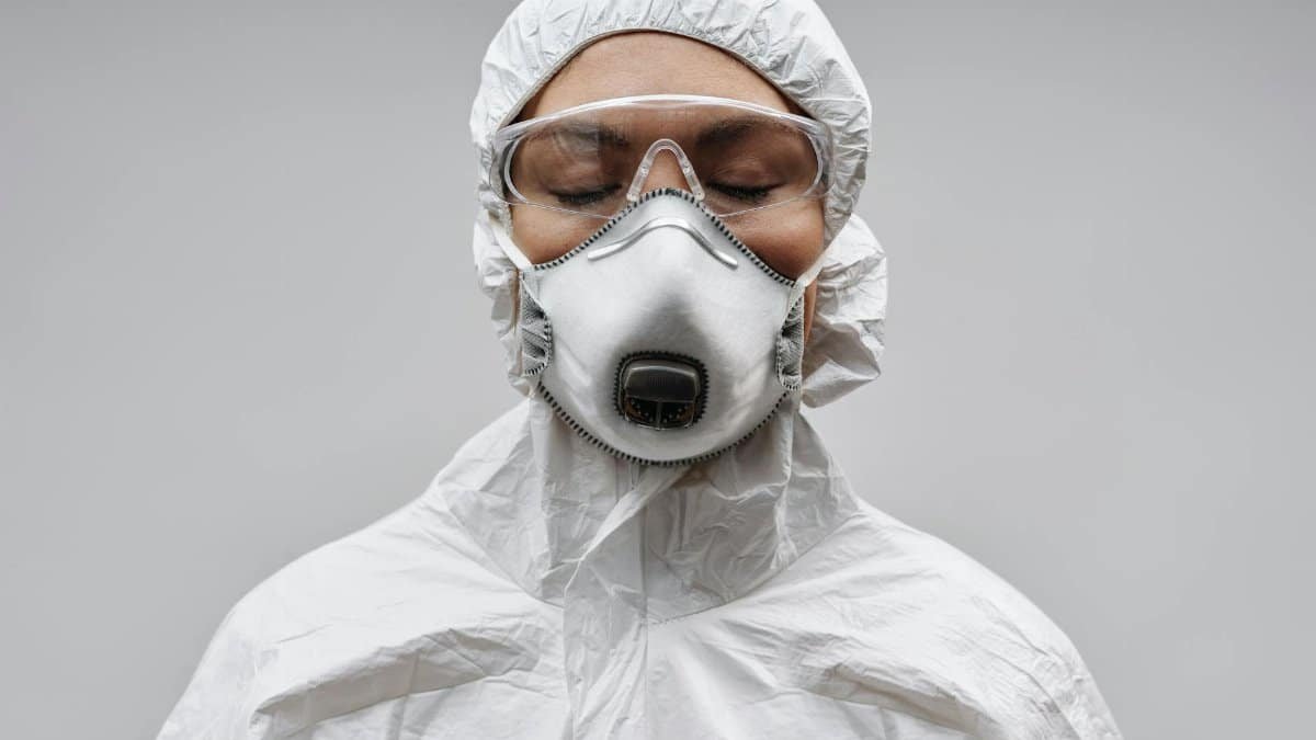 Healthcare professional wearing full protective equipment for safety and protection.