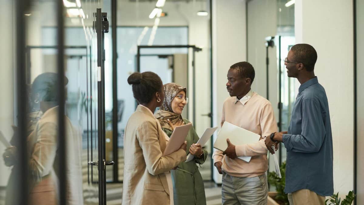 A diverse group of professionals having a discussion in a modern office setting.