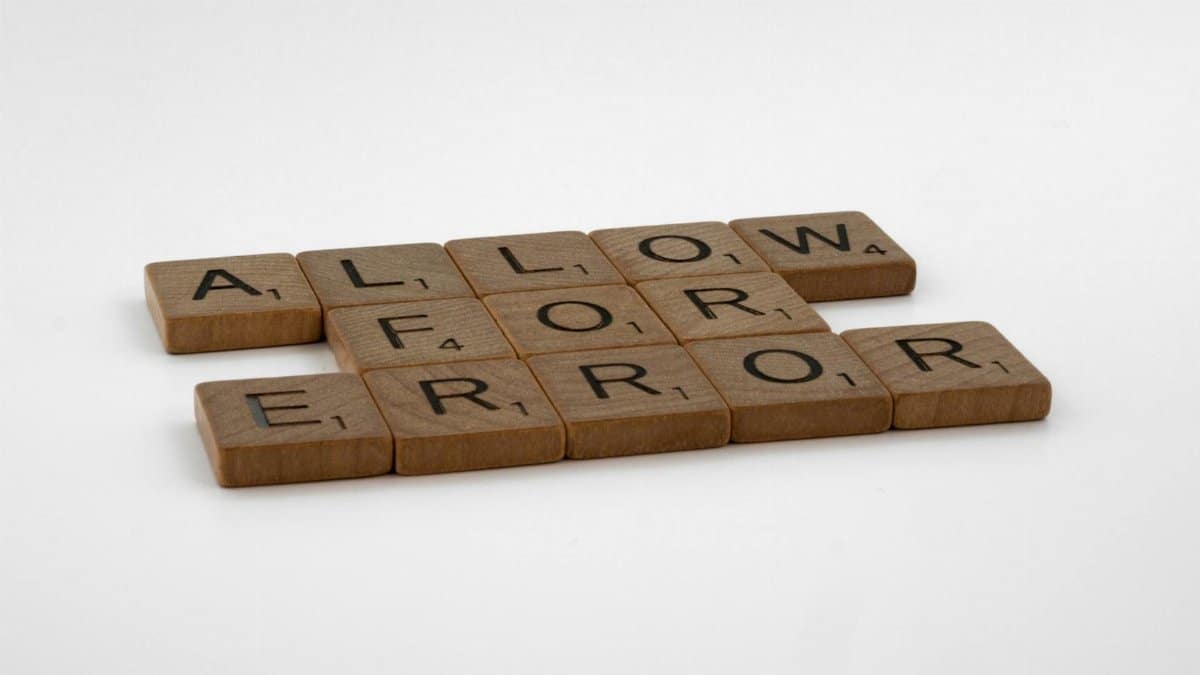 Scrabble tiles spelling 'Allow For Error' on a white background, symbolizing flexibility and acceptance.