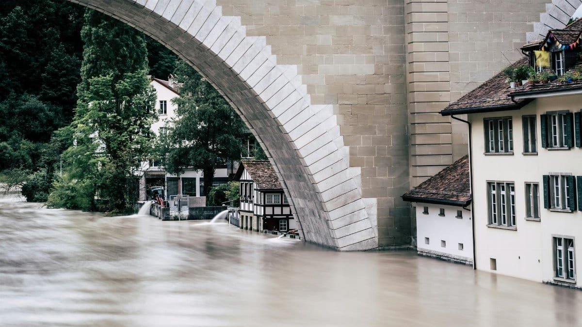 A powerful flood fills the riverbank near an iconic arch bridge in Bern, Switzerland.
