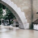 A powerful flood fills the riverbank near an iconic arch bridge in Bern, Switzerland.