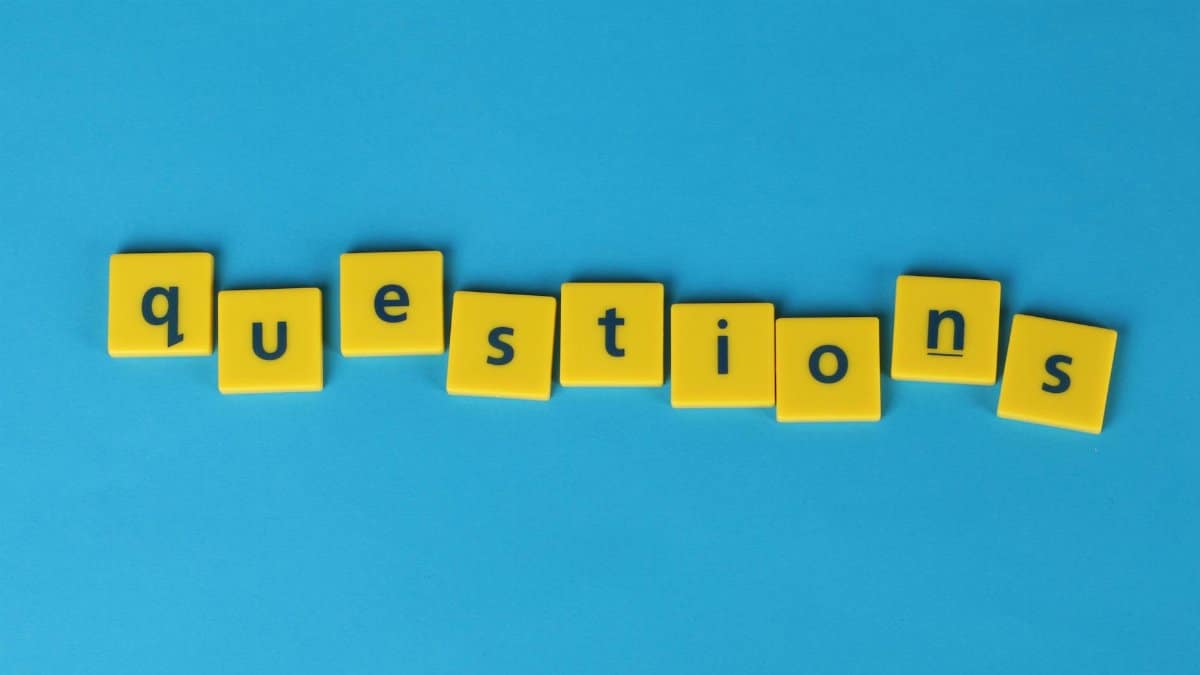 Yellow letter tiles spell 'questions' on a contrasting blue background.