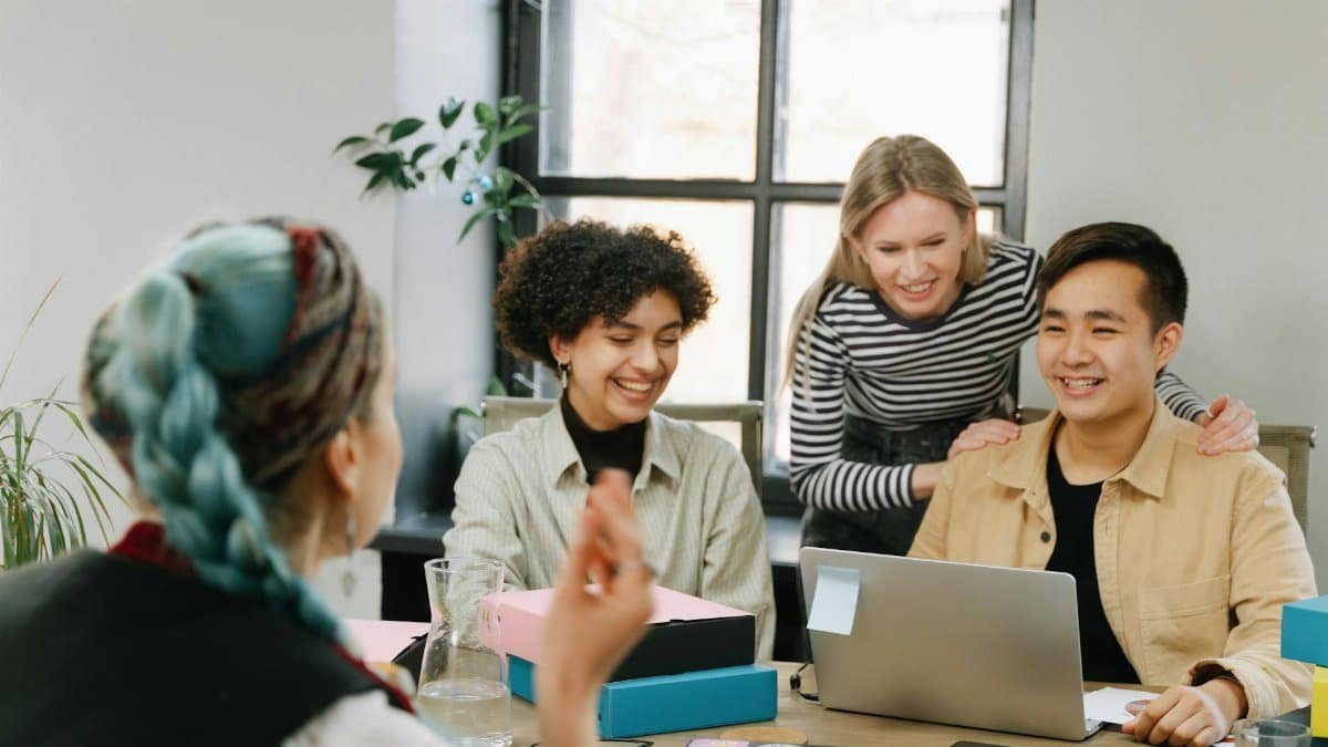 A diverse group of colleagues collaborating in a modern office, enhancing teamwork.