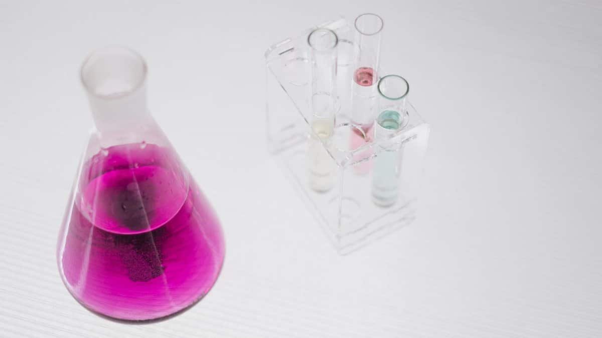 A vibrant chemistry setup with flasks and colored liquids in a lab.