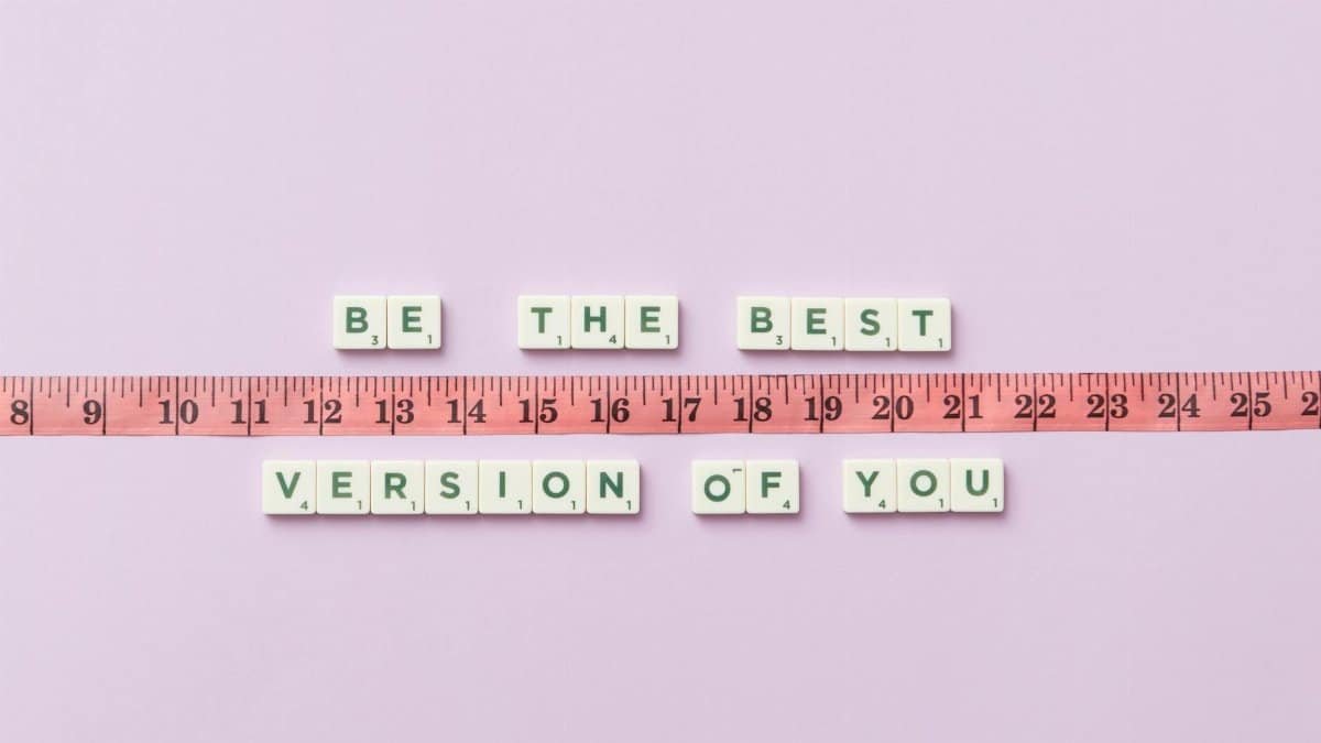 Motivational phrase 'Be the Best Version of You' with a measuring tape on purple background.