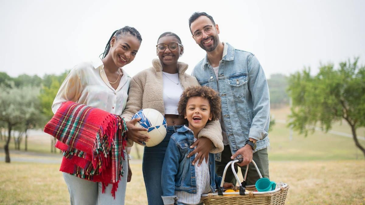 A joyful family enjoying a picnic together outdoors in Portugal's lush scenery.