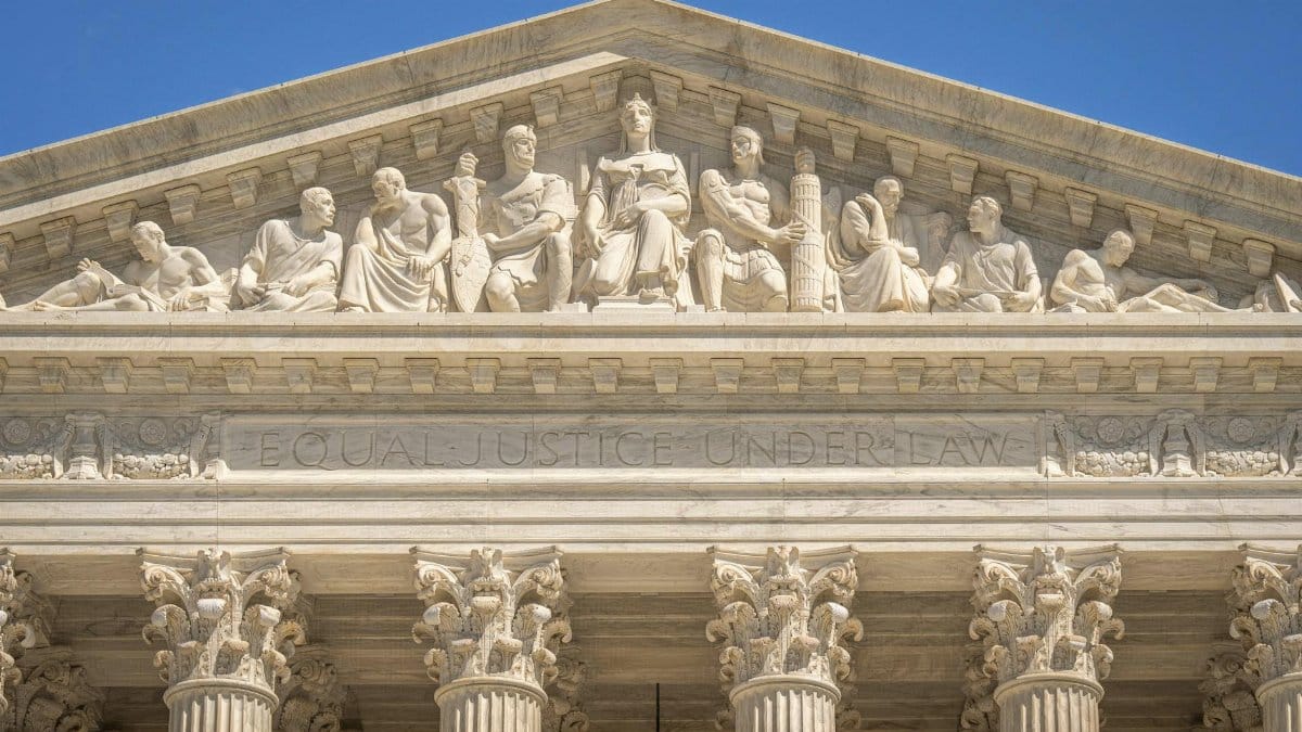 Detailed view of the Supreme Court Building's frontal frieze depicting historical figures and justices.