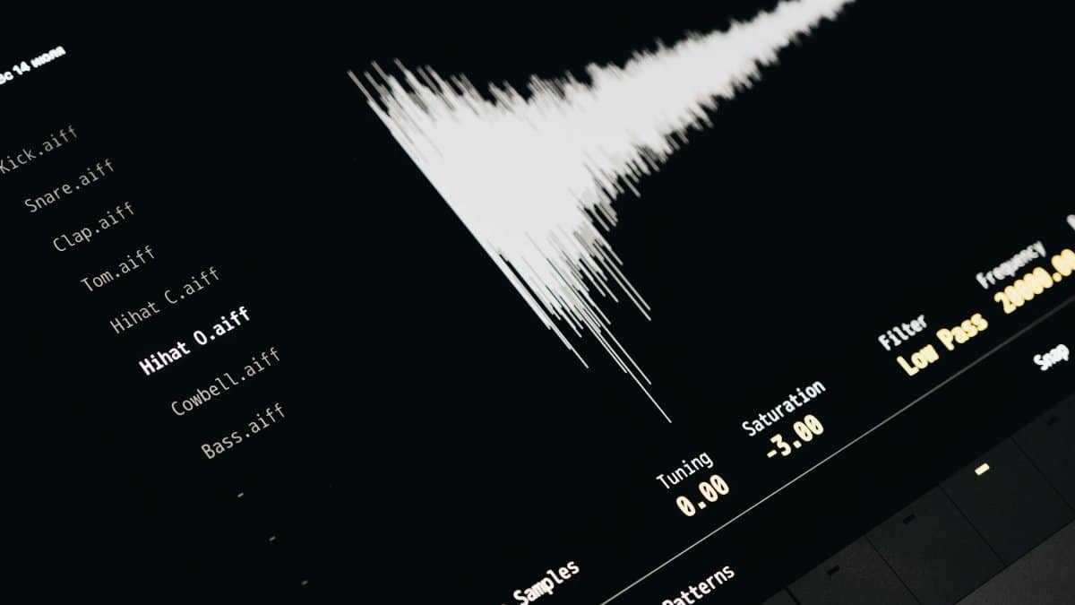 Close-up of a digital audio editing interface displaying sound waves and file names.