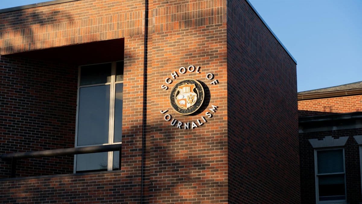 The brick facade of the School of Journalism building in Columbia, MO, captures the setting sun's glow.