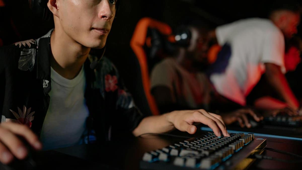 Young adults playing in a competitive esports tournament, deeply focused on gaming.