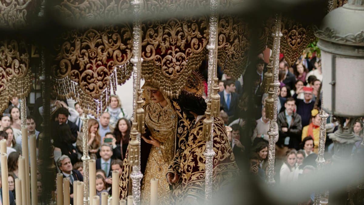 A vibrant and spiritual Semana Santa procession with a Virgin Mary statue in Seville, Spain.