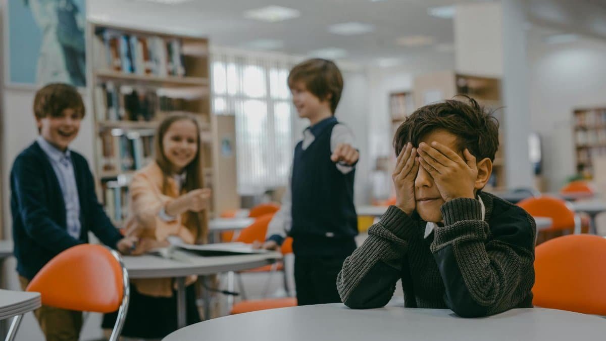 A group of children in a classroom, showing a bullying scenario.