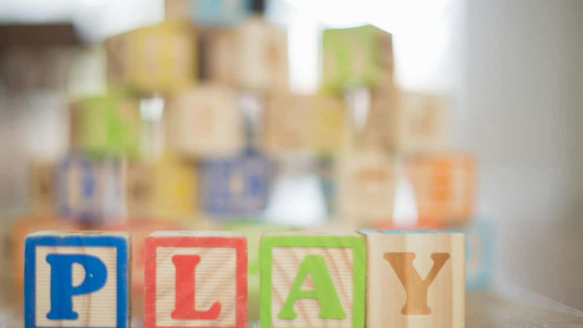 Close-up of colorful wooden blocks spelling 'PLAY', perfect for educational themes.