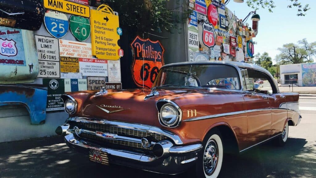 Classic Chevrolet car parked with Route 66 signage in Albuquerque, New Mexico. Nostalgic travel scene.