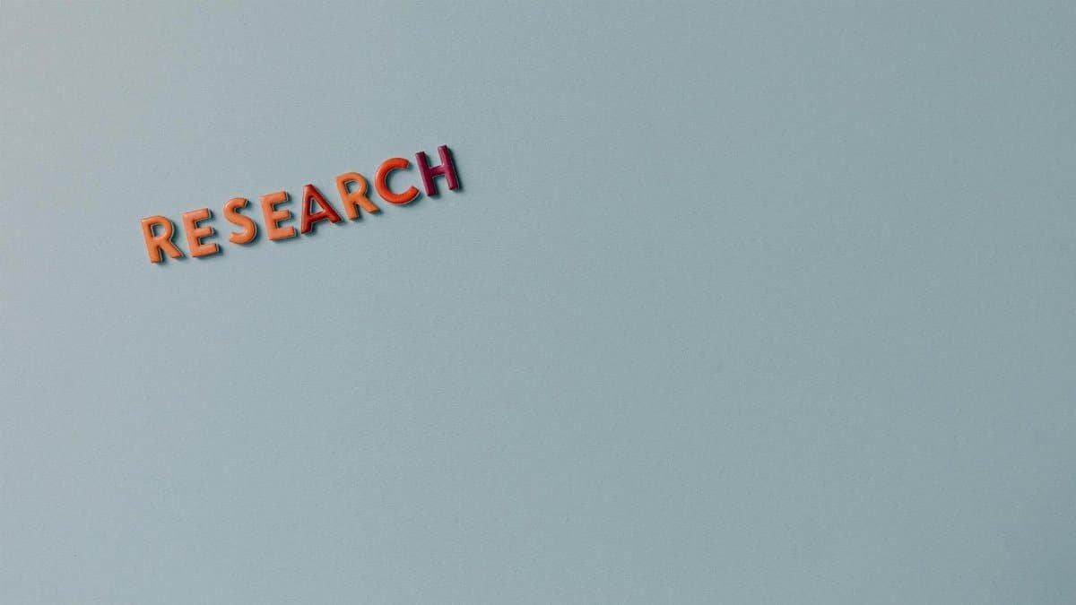 Minimalist image with the word 'RESEARCH' in colorful letters on a plain background.
