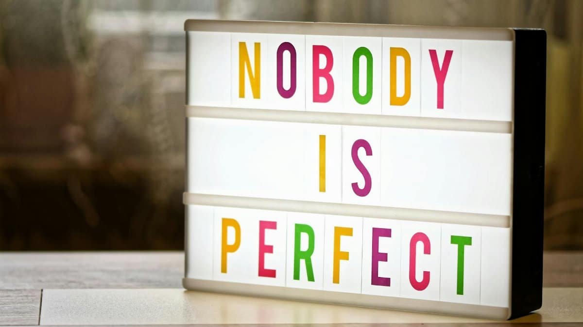 Illuminated lightbox displaying the motivational slogan 'Nobody is Perfect'.