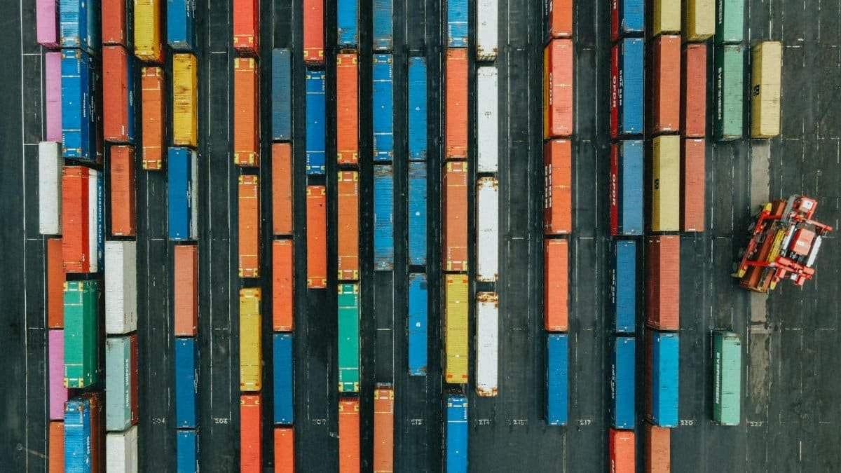 Aerial shot of colorful cargo containers in a logistics hub, Scotland.